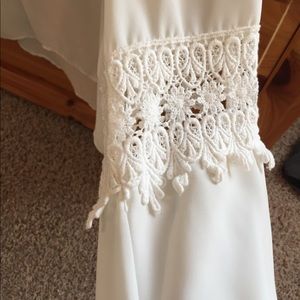 Top. Longer in the back. Beautiful sleeve detail